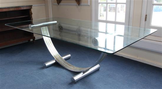 A stylish dining table with plate glass top on a U-frame two colour chrome base(-)